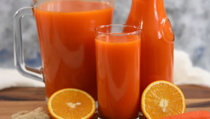 carrot orange juice in jug and glass