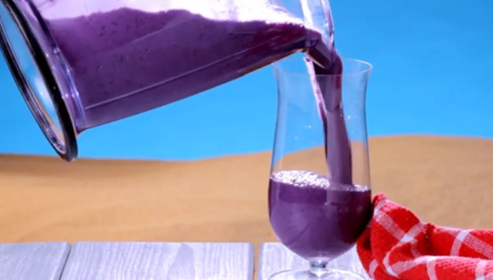 pouring blueberry juice in glass