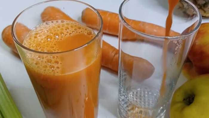 carrot celery apple juice in glass.