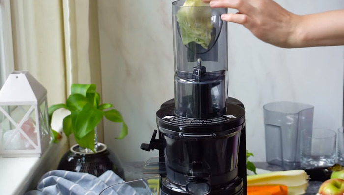 putting cabbage in juicer