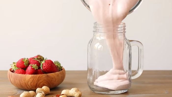 pouring smoothie in glass